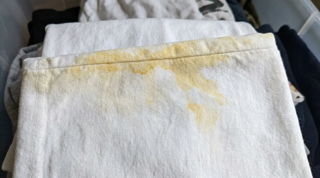 Yellow storage stains on folded white textiles