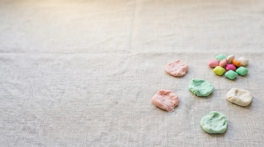 Pieces of chewed gum stuck to linen